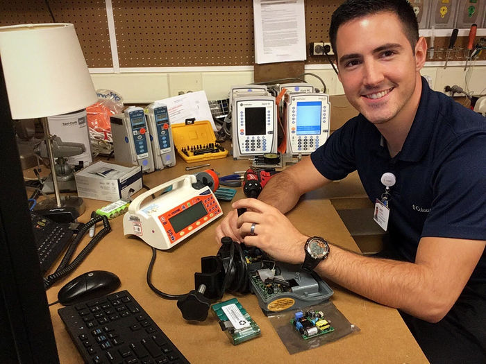 Jack DelloStritto works on hospital equipment at desk