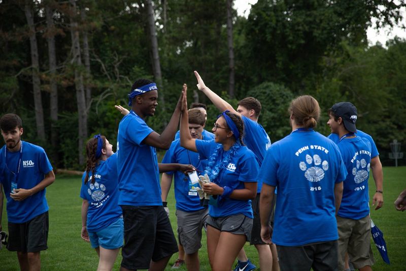 Two students high-five during games