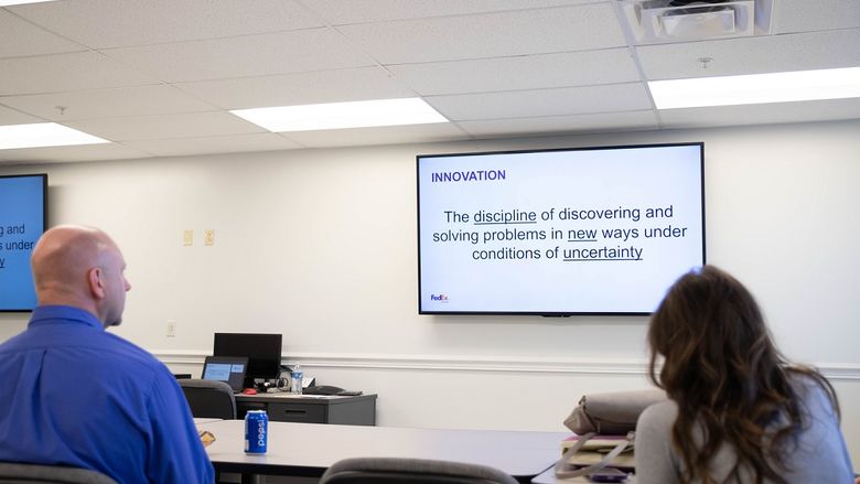 A presentation screen shows definition of "innovation"