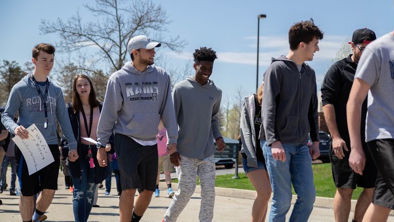 Male students walking outside