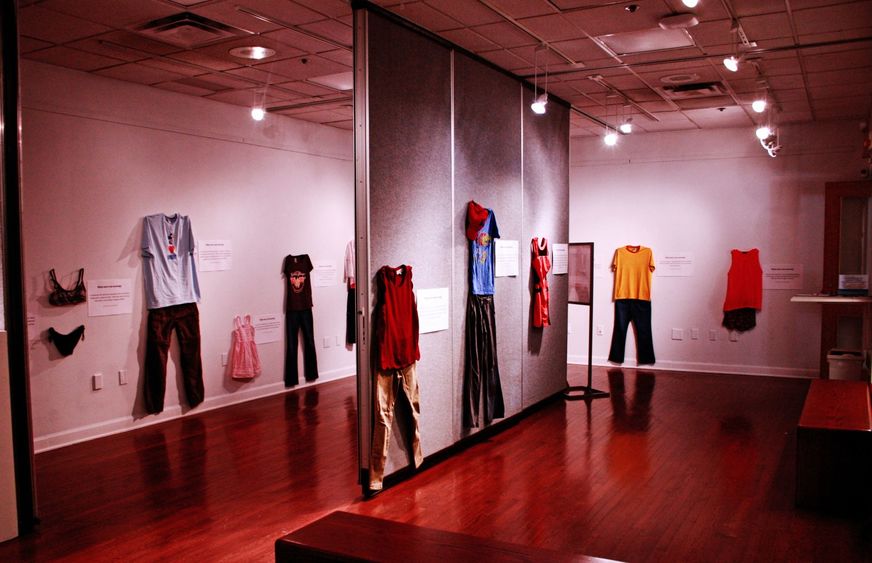 Clothing from "What Were You Wearing?" exhibit hangs on walls of gallery