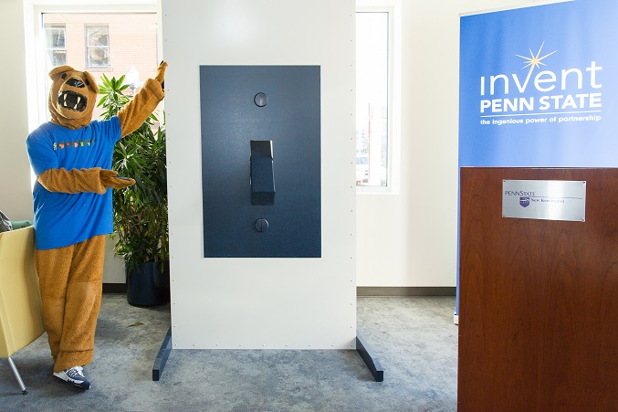 The Nittany Lion stands next to the light switch at The Corner entrepreneurial center