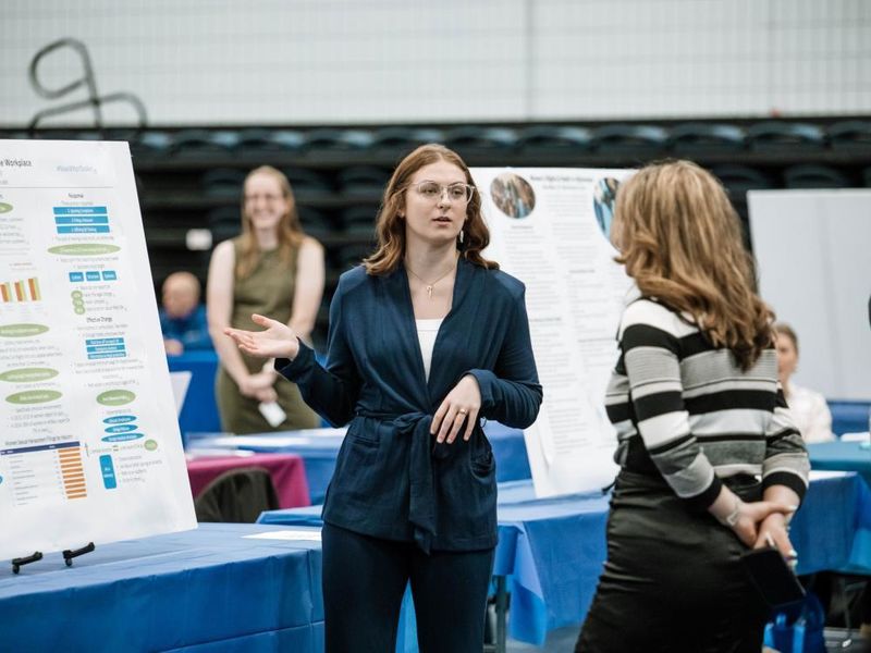 Student presents her research project at annual exposition
