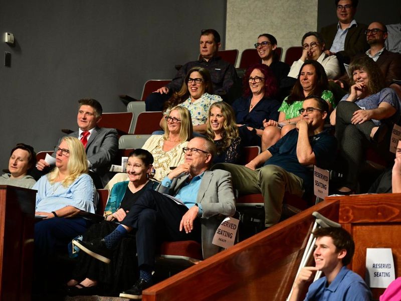 Audience members smile and laugh during the Celebration of Excellence event at Penn State New Kensington, seated in the campus theatre’s reserved section.