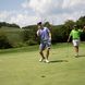Two golfers celebrate putt on golf course