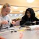 Two girls work with a 3D printing pen