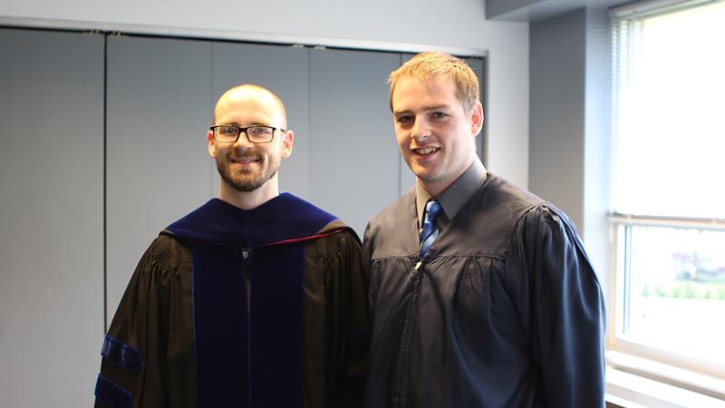 Dr. Roth and AOJ student before commencement 