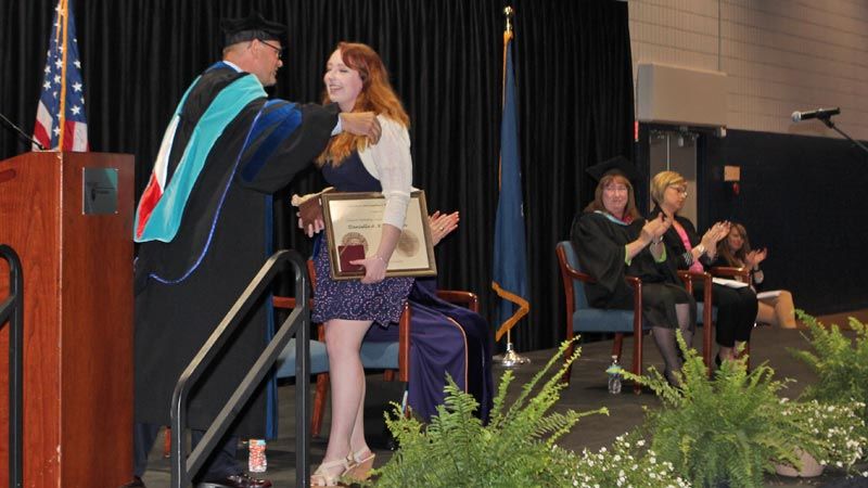 Chancellor hugs Richardson after she wins Walker Award