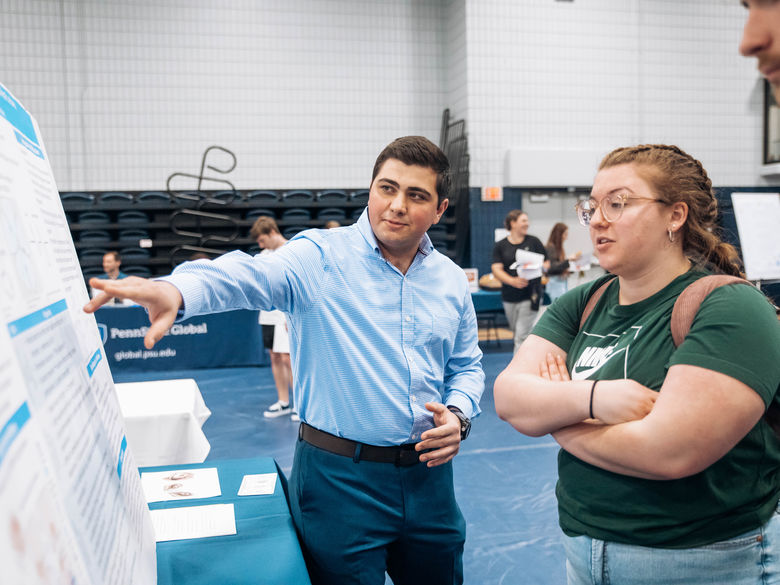 Student shares his poster presentation