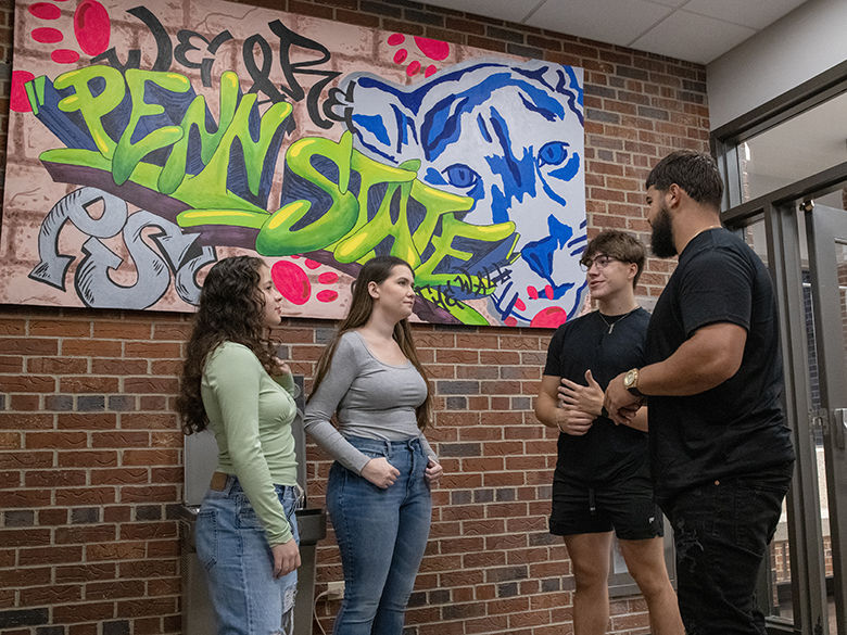 Four students talking in the hallway. 