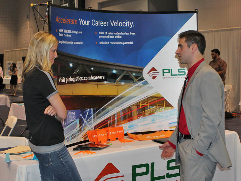 Male student talks to an employer at the Career Fair
