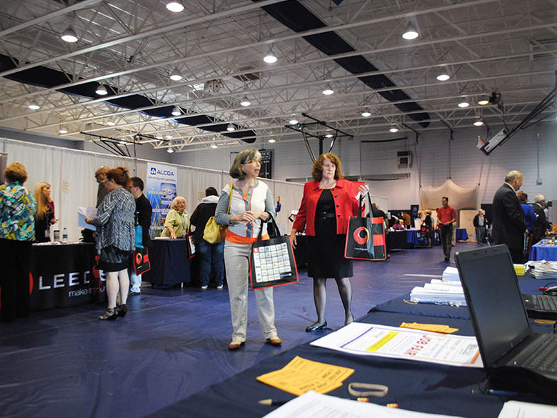 Various booths set up by companies in the gym during the annual Career Fair