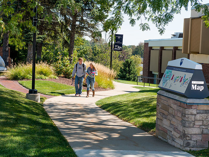 Two students walking on the campus grounds