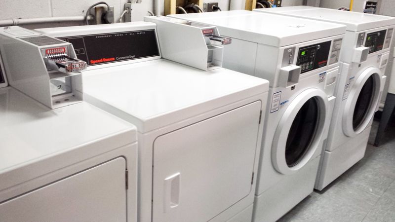 Coin-operated washers and dryers in the laundry room.