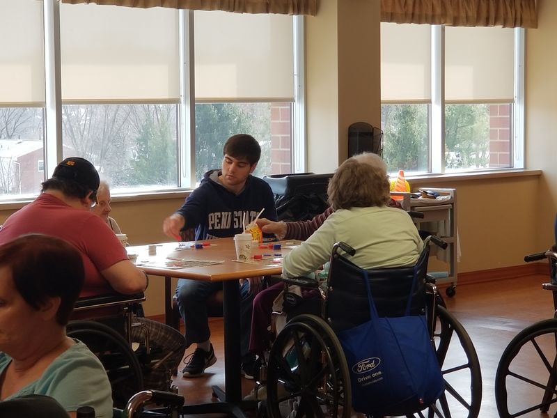 New Kensington student sits at table with Seneca Place residents to play Bingo New Kensington student sits at table with Seneca Place residents to play Bingo