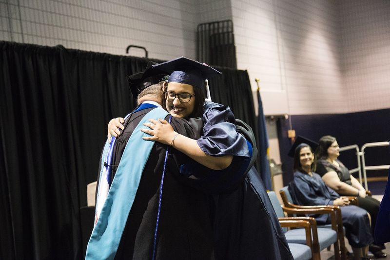 Raven Brunner hugs chancellor during commencement