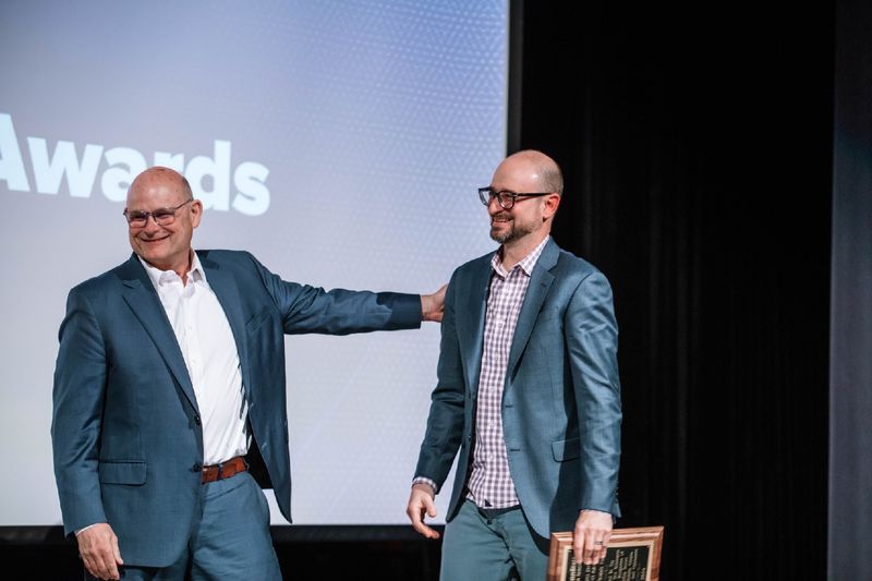 Kevin Snider and Joe Cuiffi laughing during awards ceremony