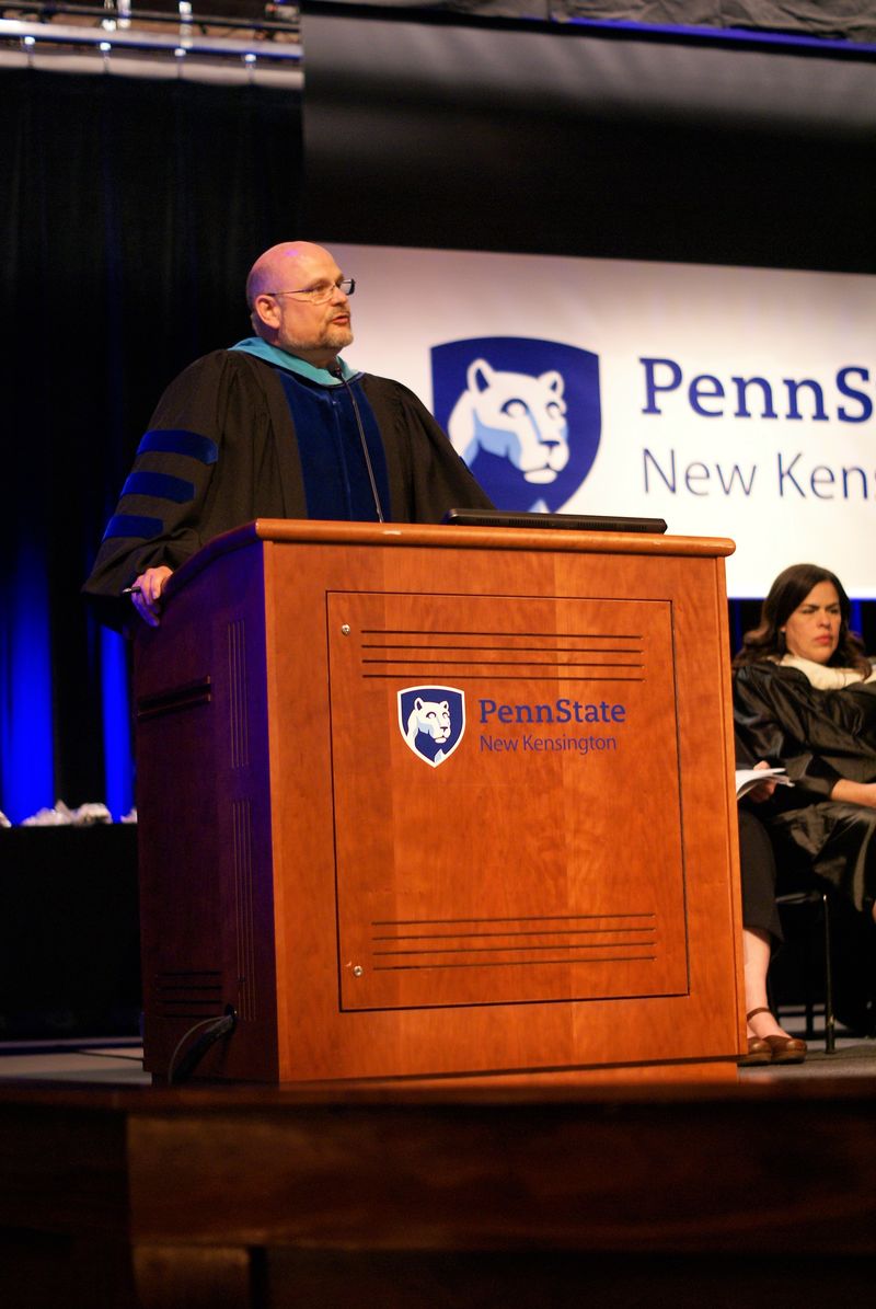 Dr. Kevin Snider speaks at a podium during awards ceremony