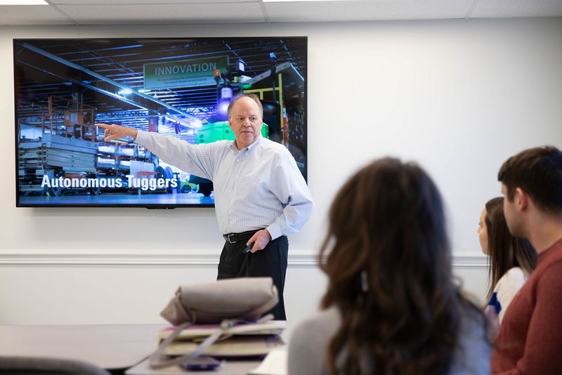 Man points to presentation