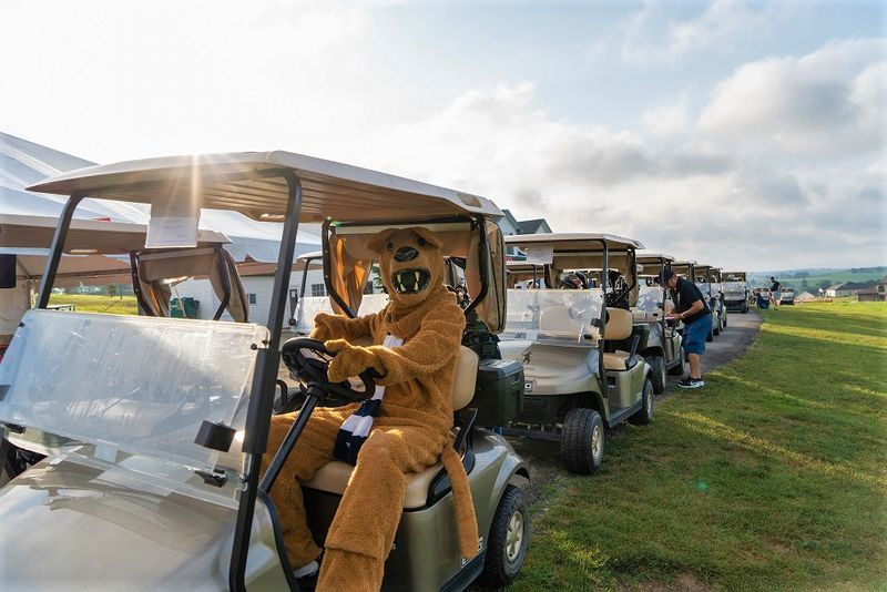 Nittany Lion mascot sits in golf cart