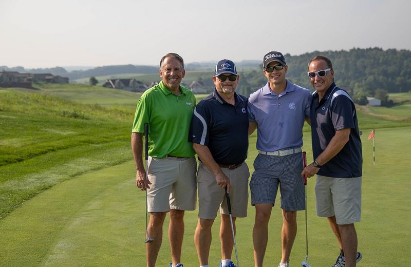 Golfers pose for photo at golf outing