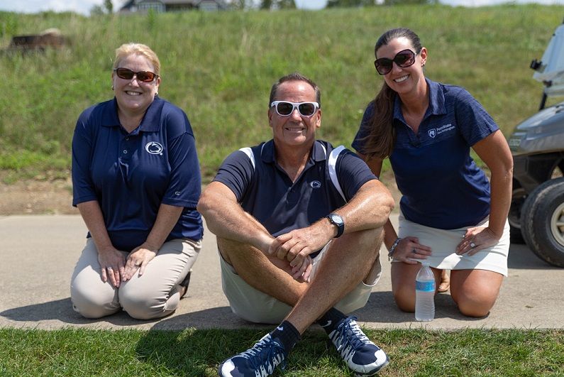 Three alumni society members at golf outing