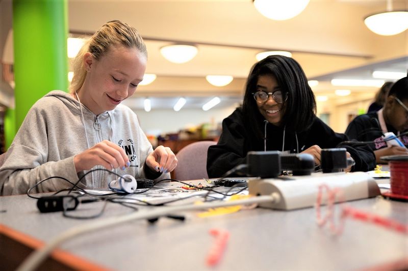Two girls work with a 3D printing pen Two girls work with a 3D printing pen