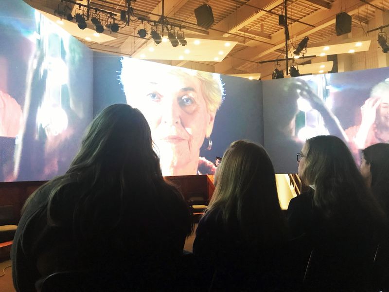 Students watching videos on large screen Students watch "FaceAge" multimedia exhibit at Penn State New Kensington