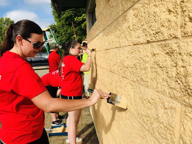 Staff painting wall