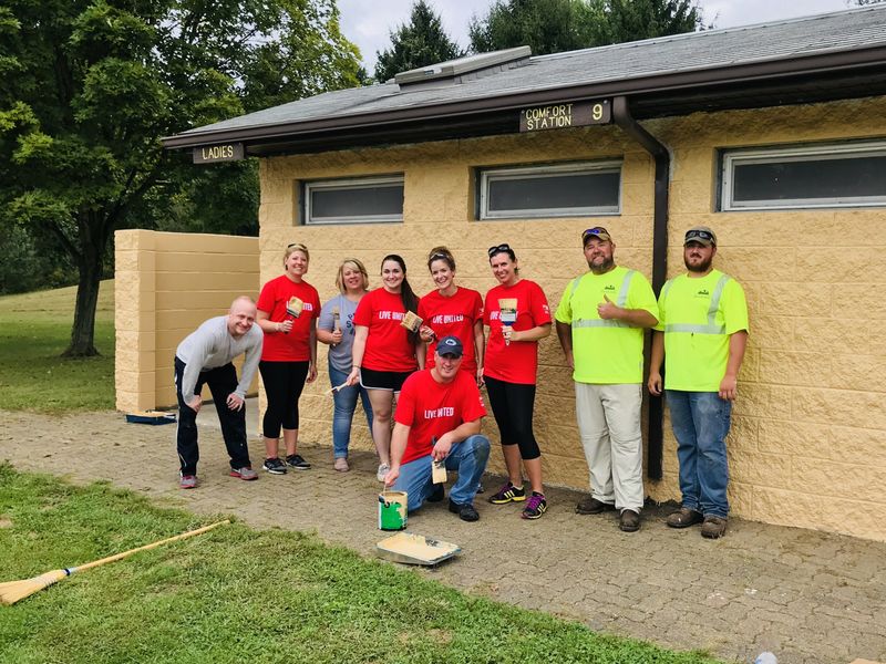 Penn State New Kensington staff holding painting supplies Penn State New Kensington Day of Caring 2018