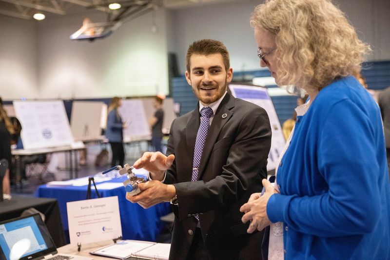 Student talks to woman about research