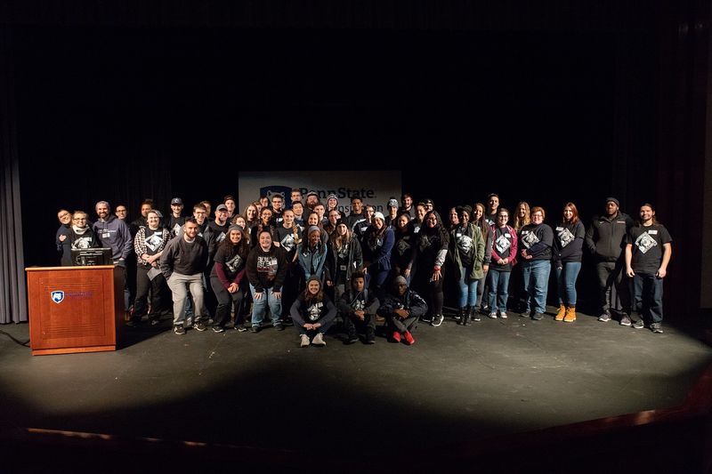 Students take group photo on stage Students take group photo on stage