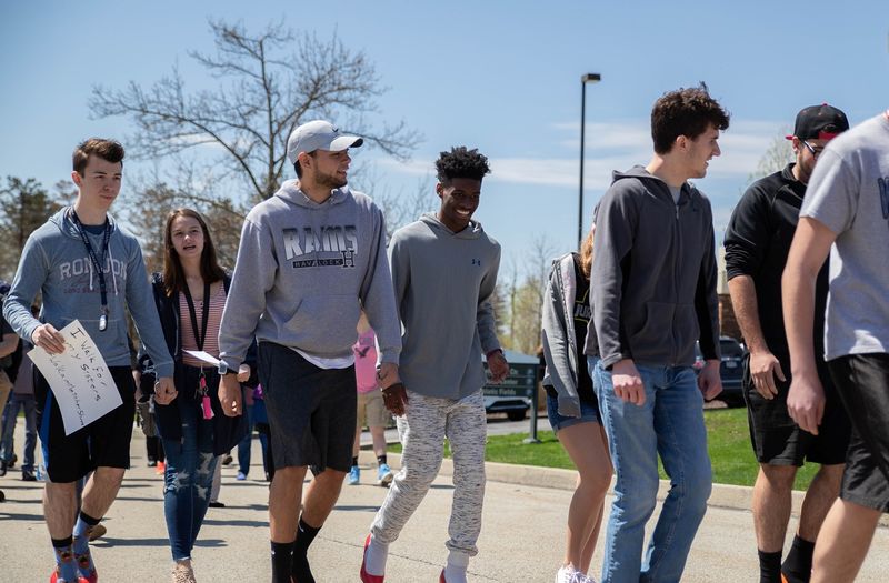 Male students walking outside Male students walking outside