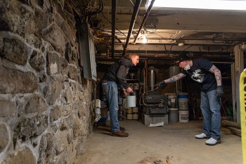 Two students moving items