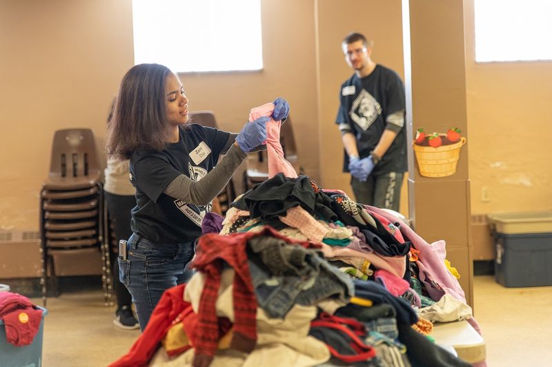 Student sorting clothes at the Salvation Army