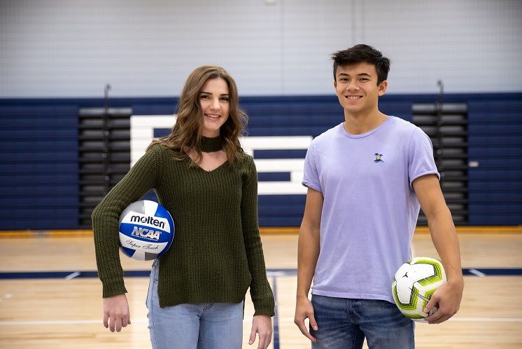 Woman and man stand in gymnasium Woman and man stand in gymnasium