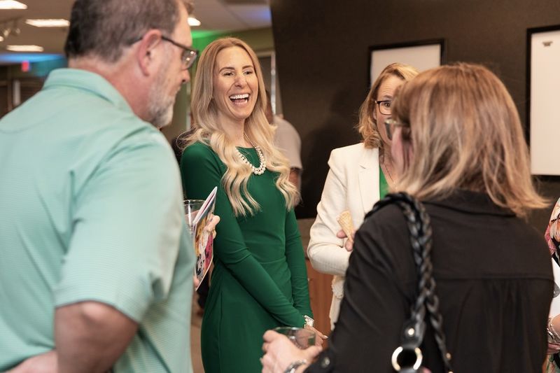 Woman laughs while talking with group