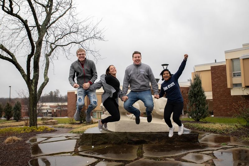 Four students jump in the air Four students jump in the air