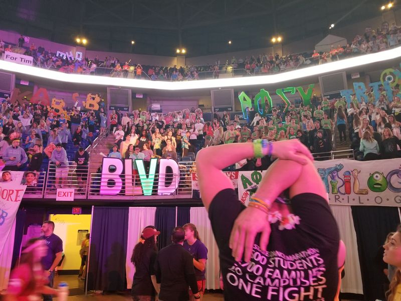THON dancer Nick Roth leads team stretch at THON 2018