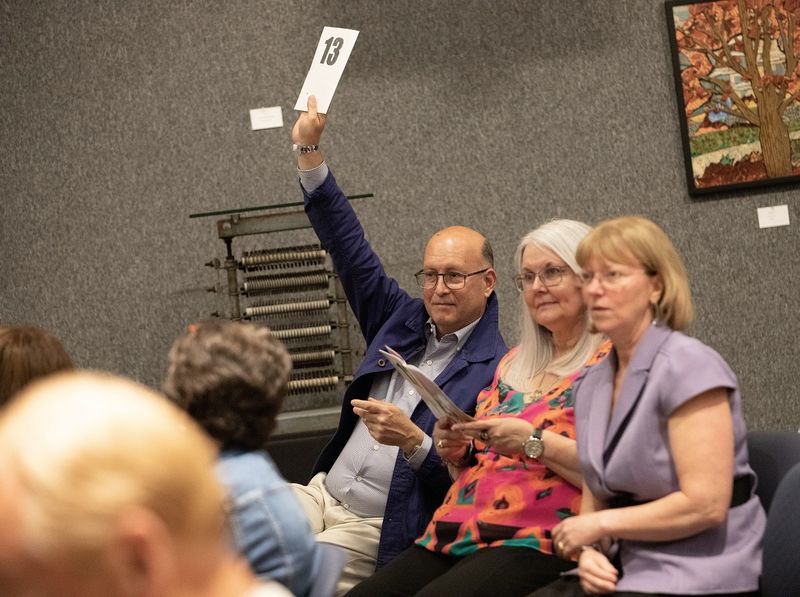 Man holds up number during art auction