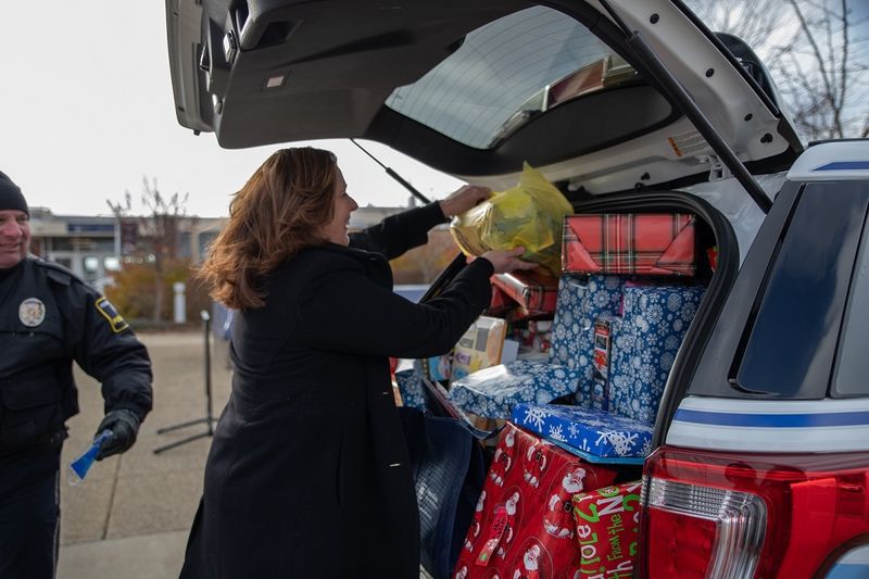Woman places gifts in car