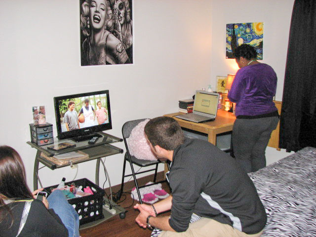 Students watching TV in a bedroom