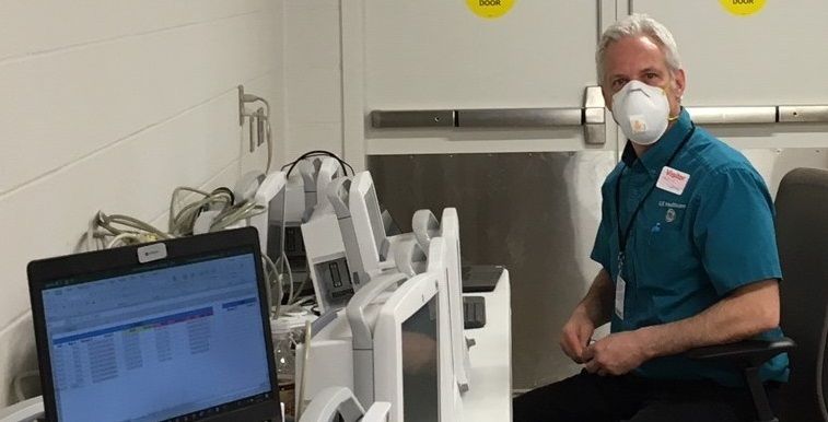Man sitting next to medical equipment Man sitting next to medical equipment