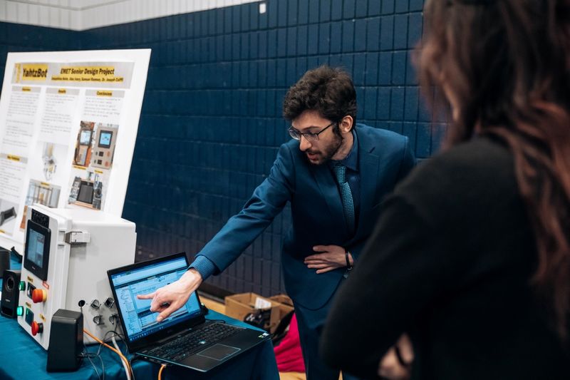 Student points at computer