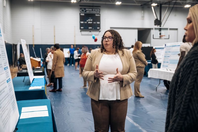 Student stands at research fair