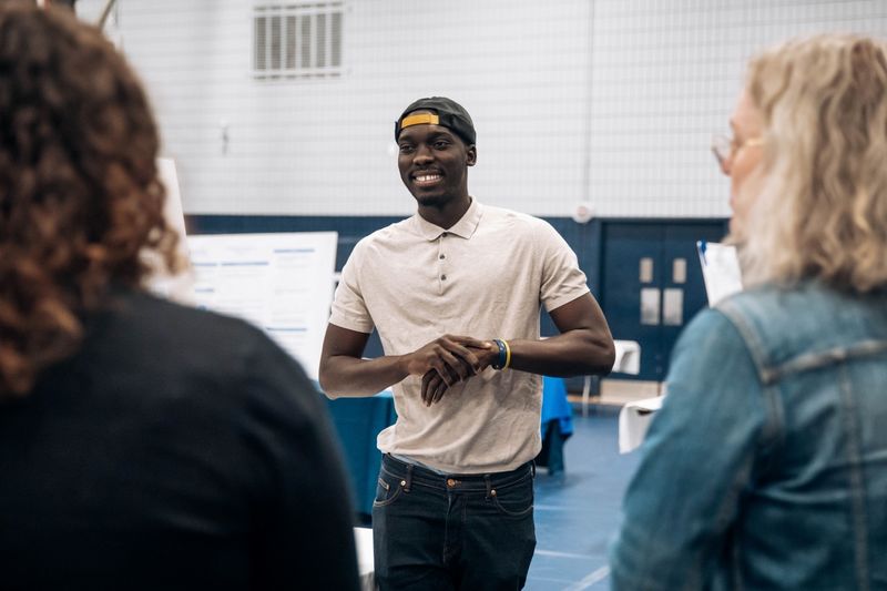 Student smiles at research fair