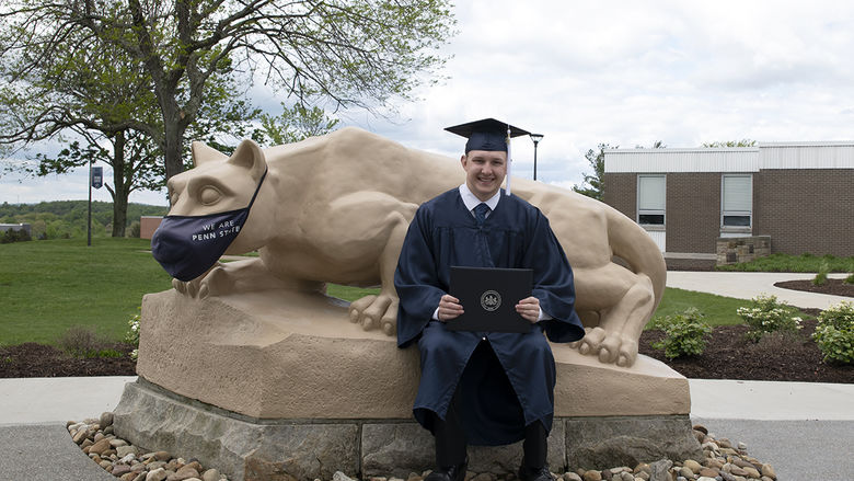 Bailey Stapleton sitting with the Lion Shrine.