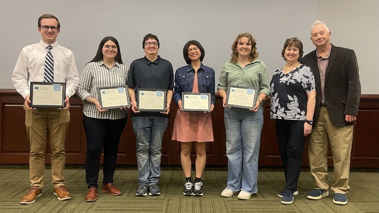 5 students holding awards standing next to John Sr. and Kimlyn Patishnock 