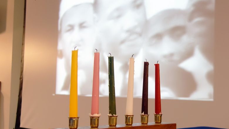 The unity candle is surrounded by images of Dr. Martin Luther King, Jr.