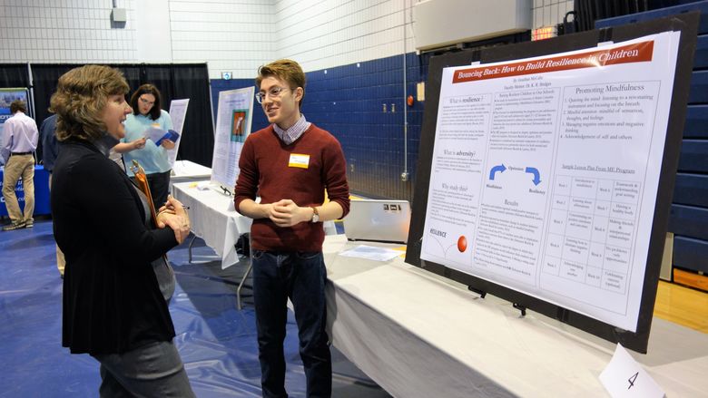 Jonathan McCabe, senior psychology student, presents his research poster at the 2018 Research and Creative Exposition